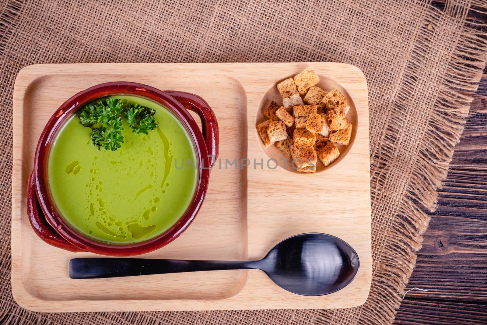 Fresh asparagus creamy soup and ingredients on a wooden table. by Fischeron