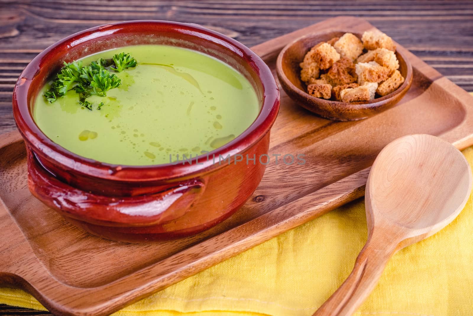 Fresh asparagus creamy soup and ingredients on a wooden table. by Fischeron