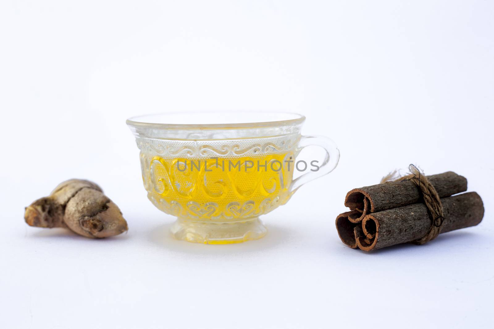Popular turmeric tea isolated on white with its entire ingredients which are turmeric powder and raw, honey and cinnamon sticks.Used for detoxifying body.Isolated on white. by mirzamlk