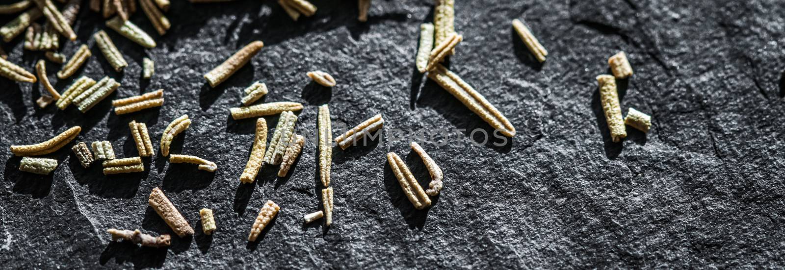 Rosemary closeup on luxury stone background as flat lay, dry food spices and recipe ingredient by Anneleven