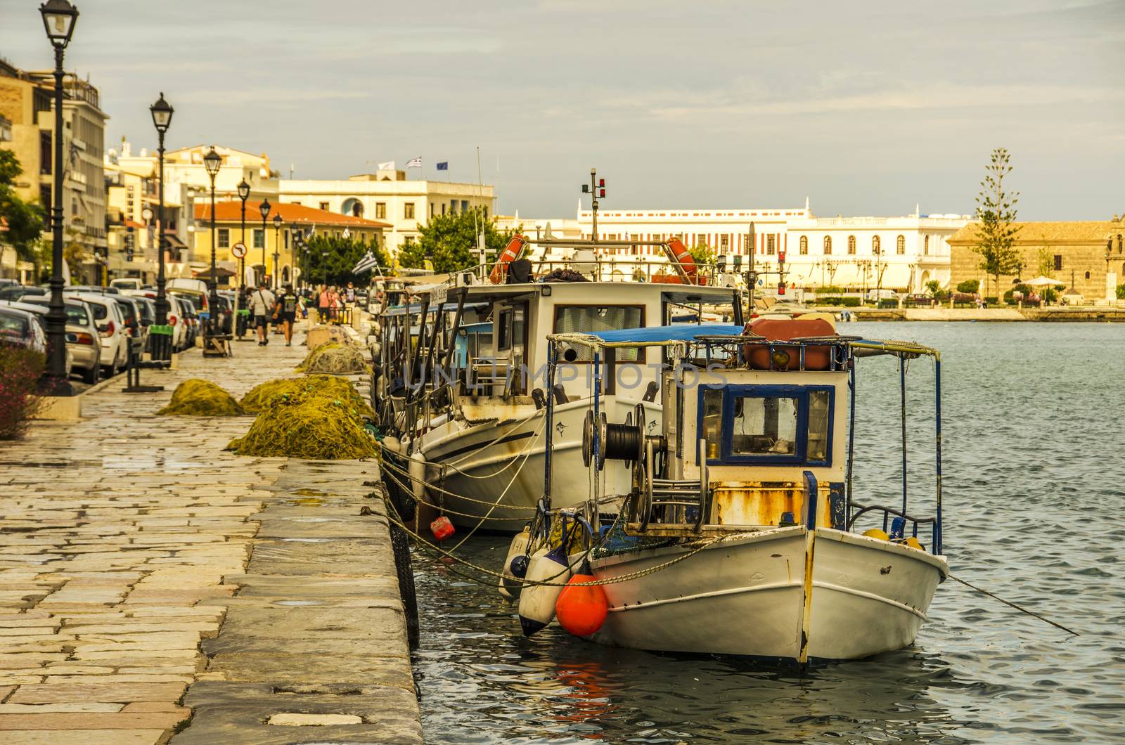 Fishing boats with their nets moored in the port of the city of Zakynthos which is also the main city of the island of Corfu. In the background you can see the old catholic church of the city.