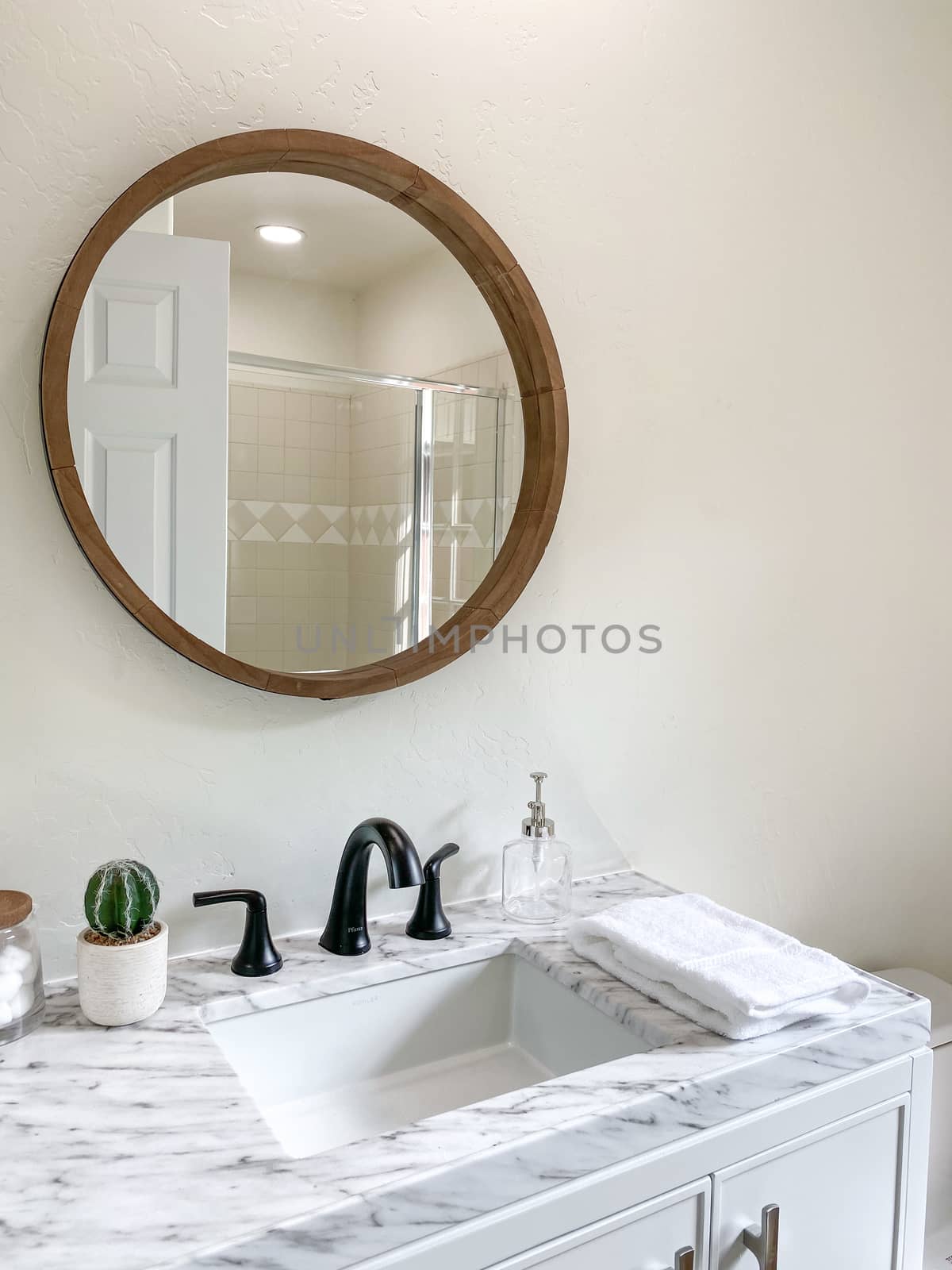 Round mirror sink in stylish bathroom interior  by Bonandbon