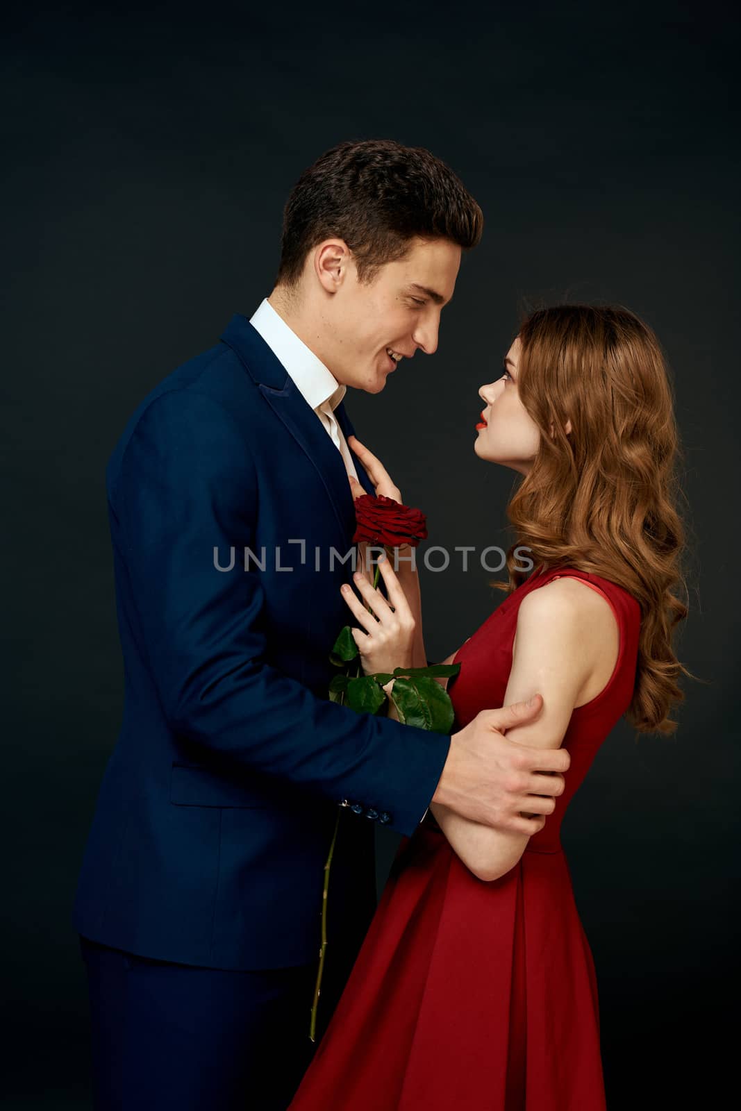 Beautiful couple charm hug lifestyle relationship rose luxury dark background by SHOTPRIME