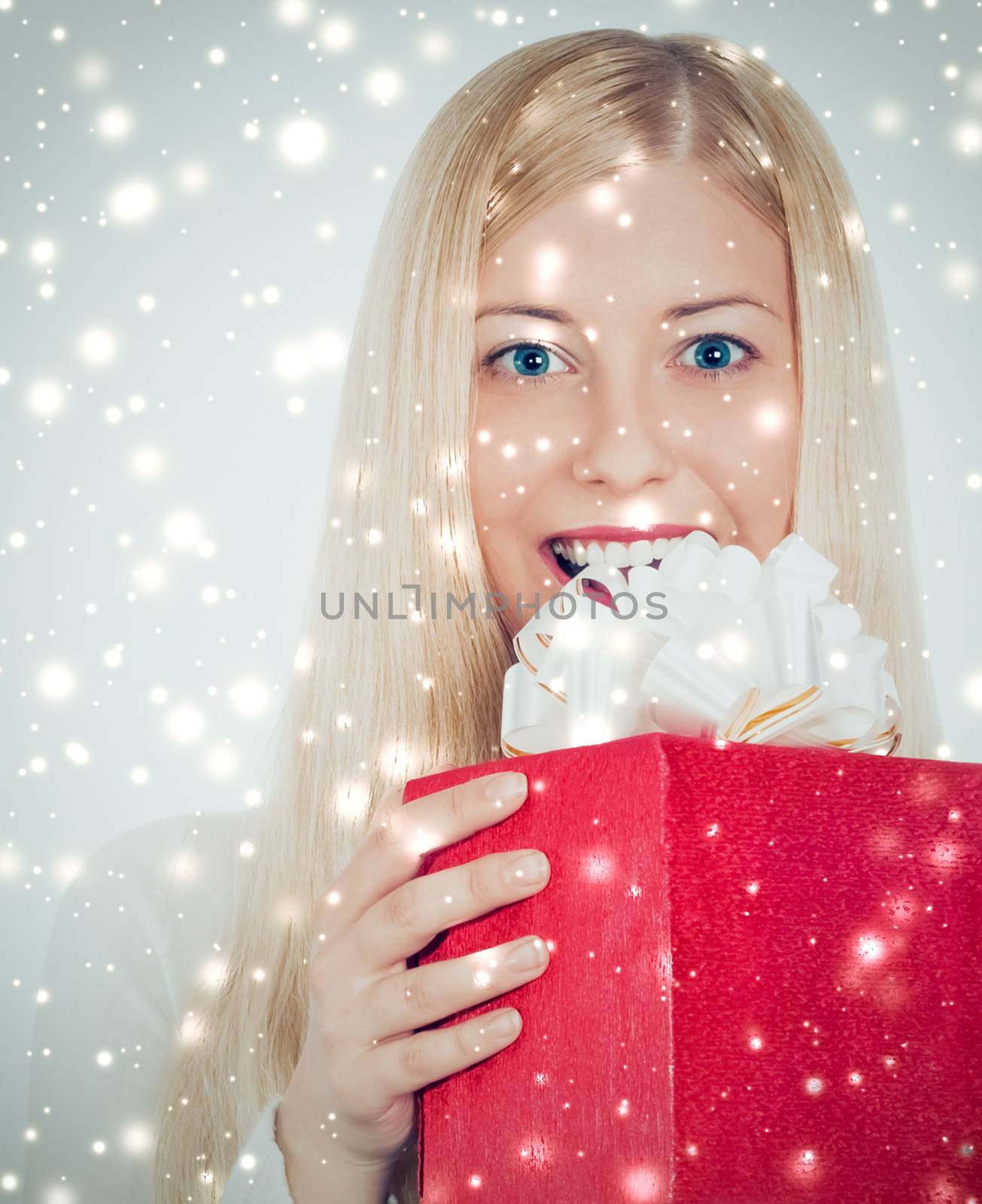 Christmas surprise and glitter snow background, happy blonde model with gift boxes in winter season for shopping sale and holiday brands