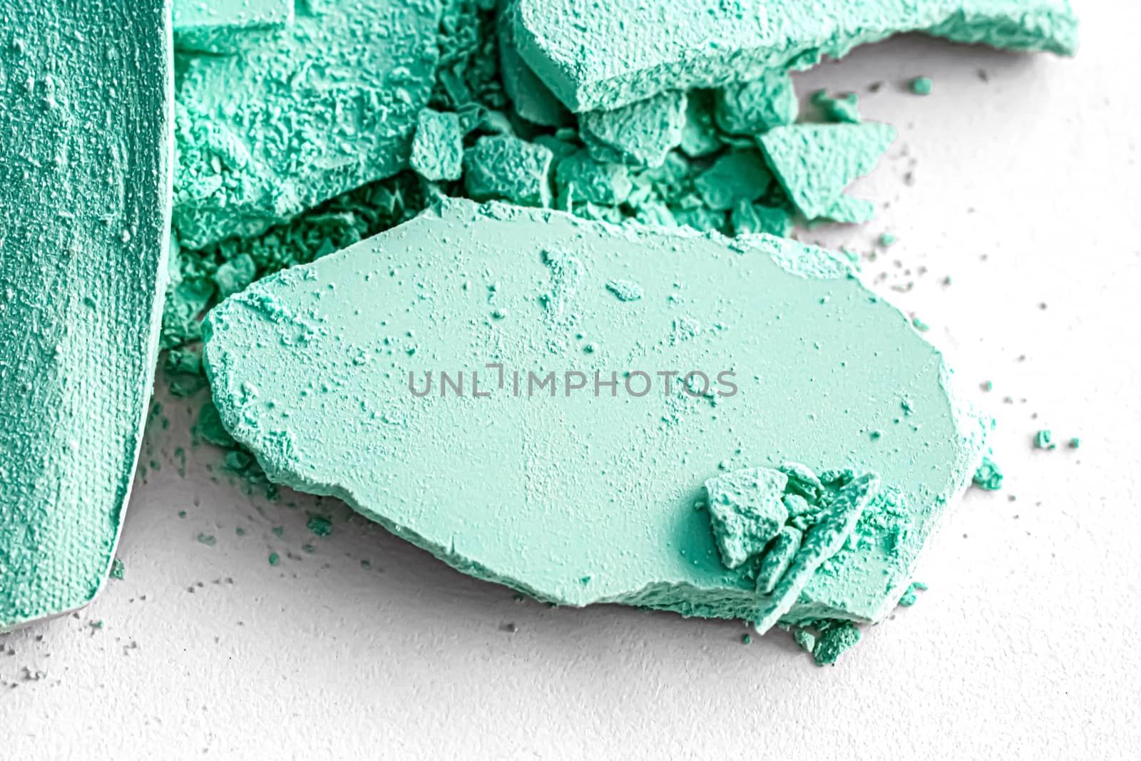 Mint eye shadow powder as makeup palette closeup isolated on white background, crushed cosmetics and beauty textures