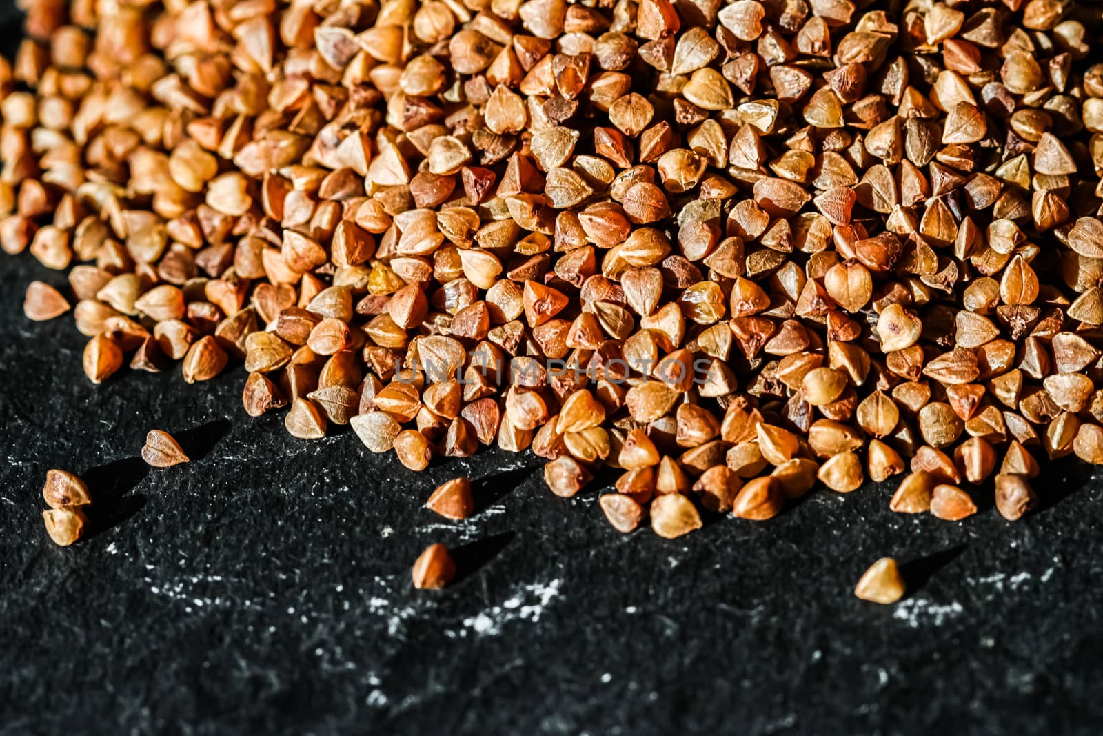 Buckwheat grain closeup, food texture and cook book background by Anneleven