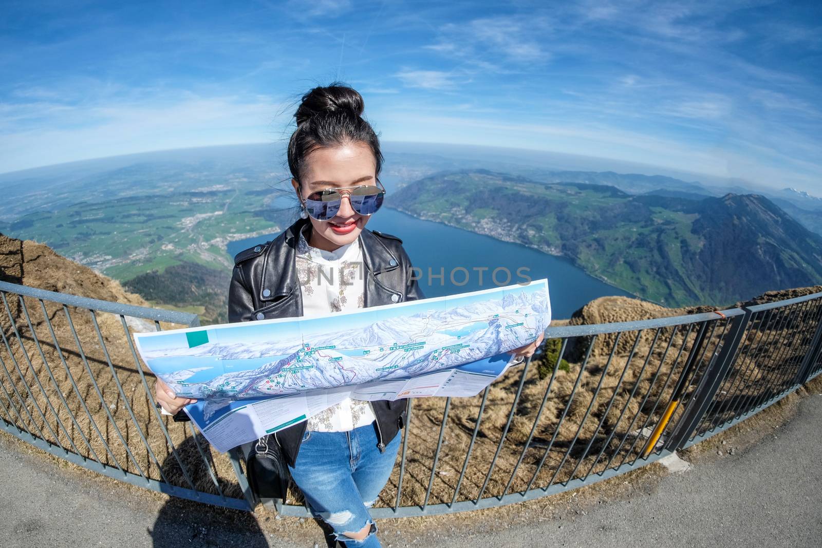 Young female tourist looking map at Rigi mountain in Switzerland by Surasak