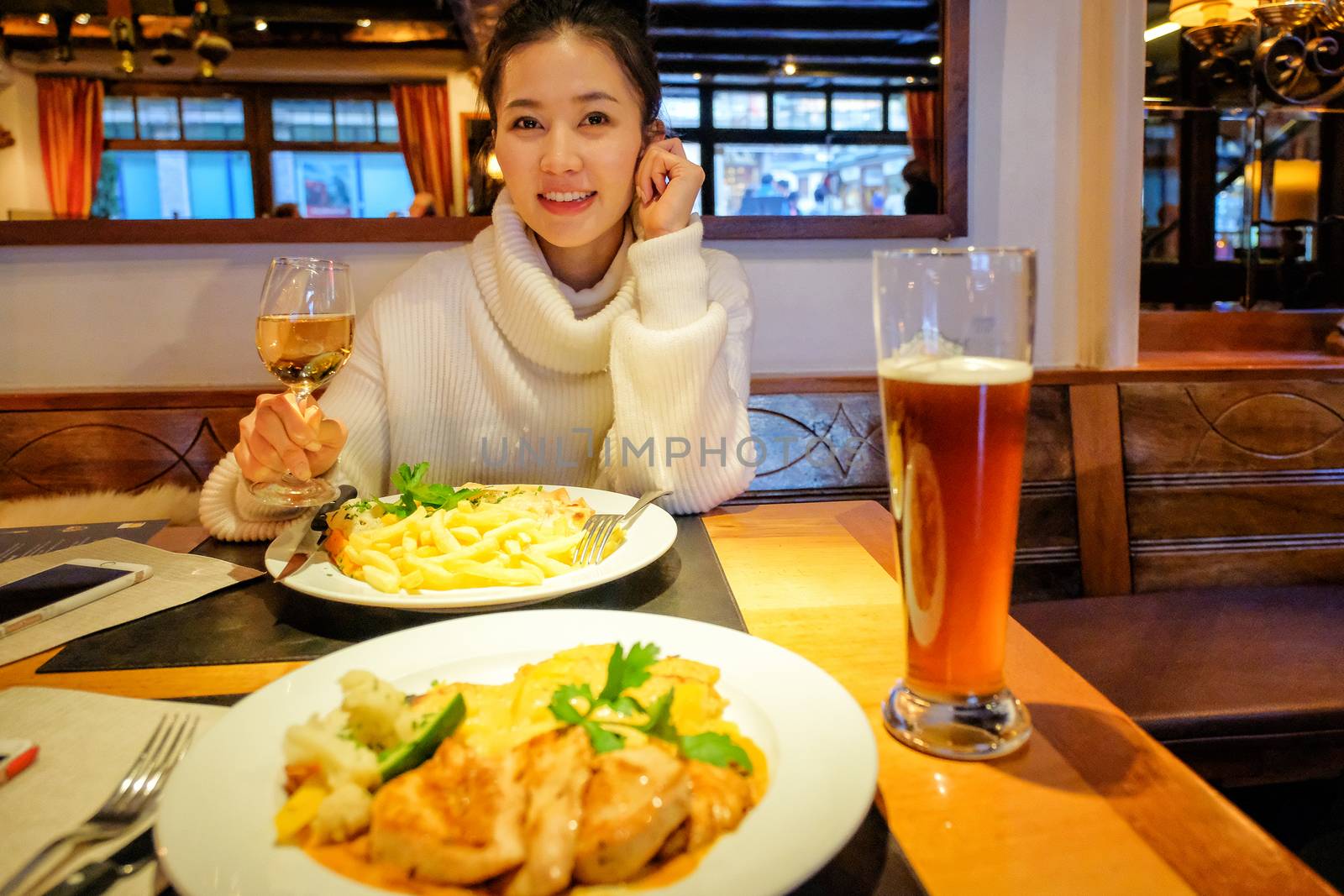 Young asian woman having dinner in restaurants,zermatt,switzerland