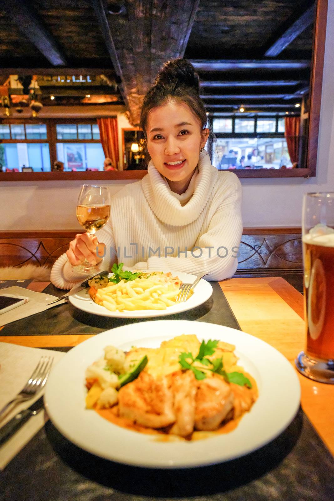 Young asian woman having dinner in restaurants,zermatt,switzerland