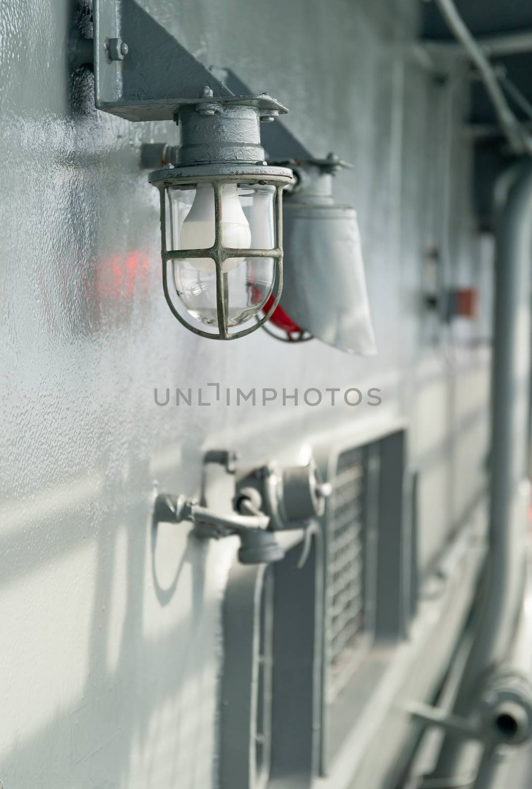 Deck lamp on ship with metal frame fixed in protective cage