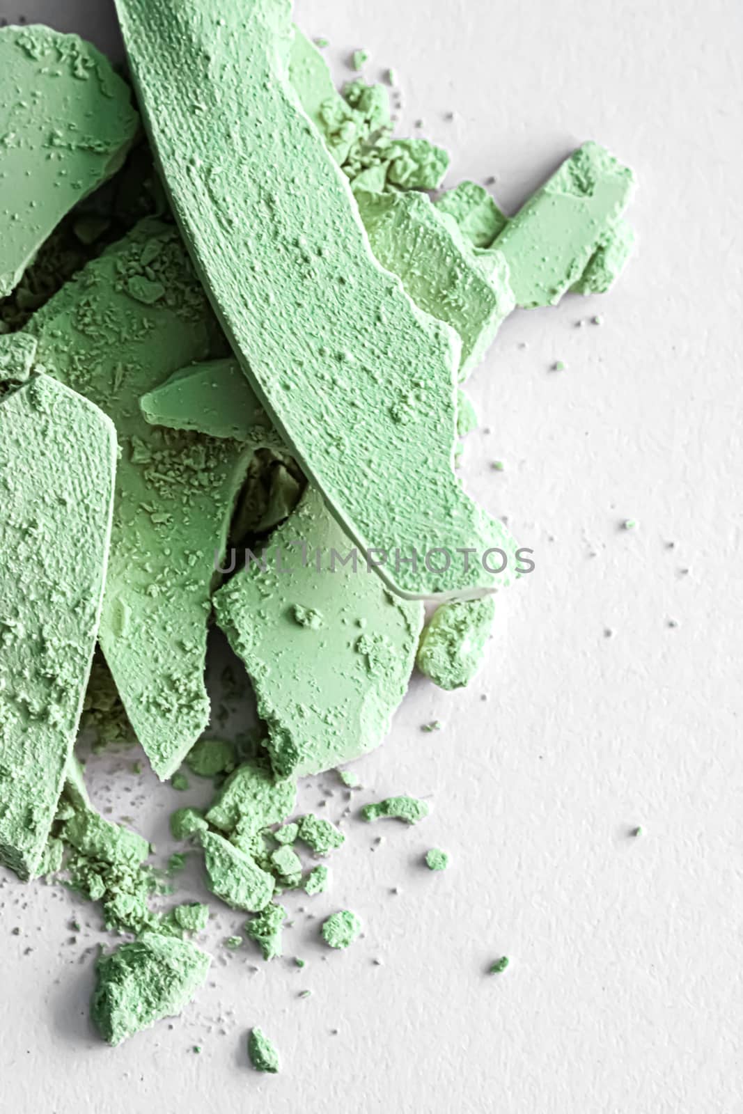 Green eye shadow powder as makeup palette closeup isolated on white background, crushed cosmetics and beauty textures