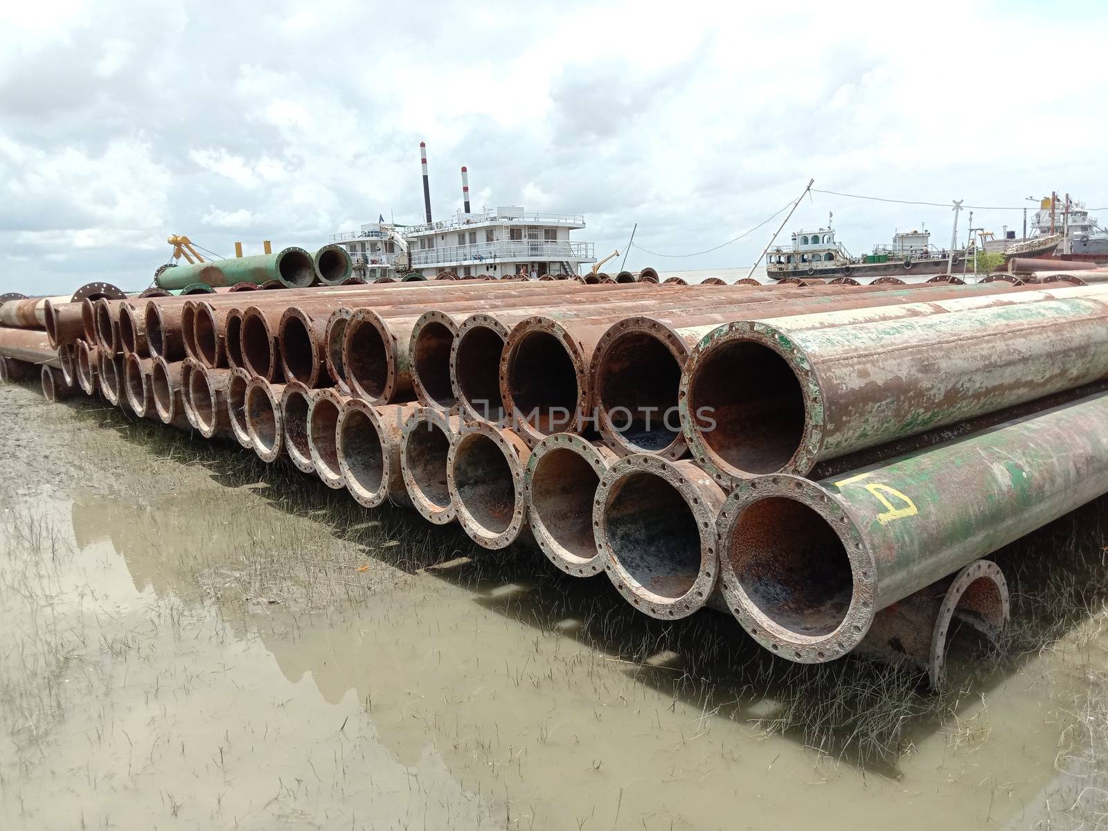 old Iron pipe stock near of river for sand collection