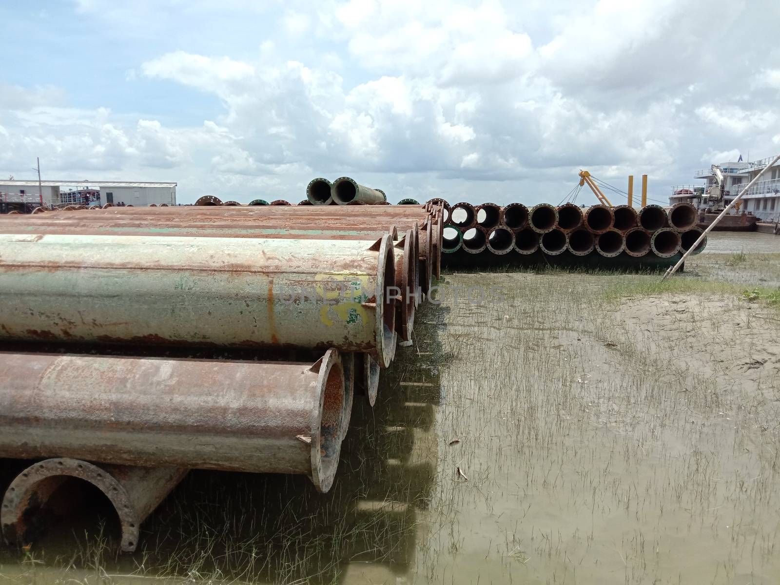 old Iron pipe stock near of river for sand collection