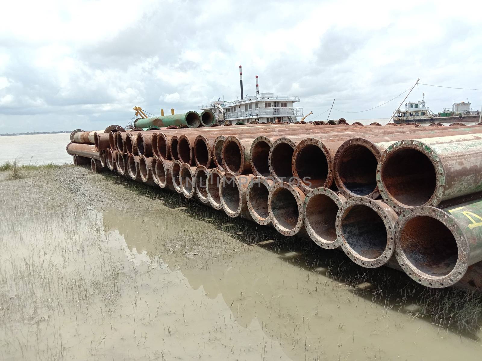 old Iron pipe stock near of river for sand collection