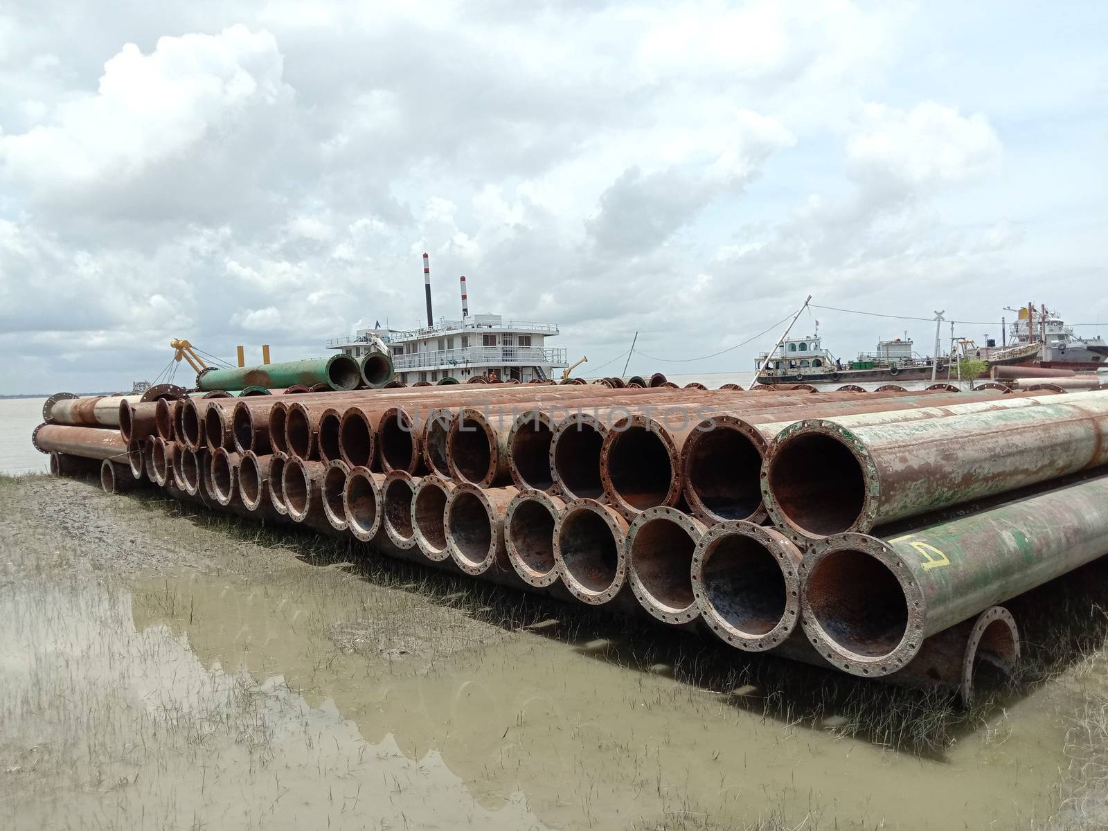 old Iron pipe stock near of river for sand collection