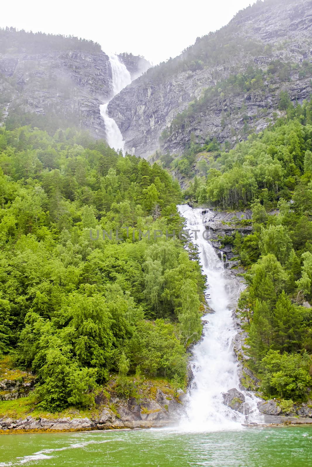 Waterfall in Aurlandsfjord Aurland Sognefjord in Norway. by Arkadij