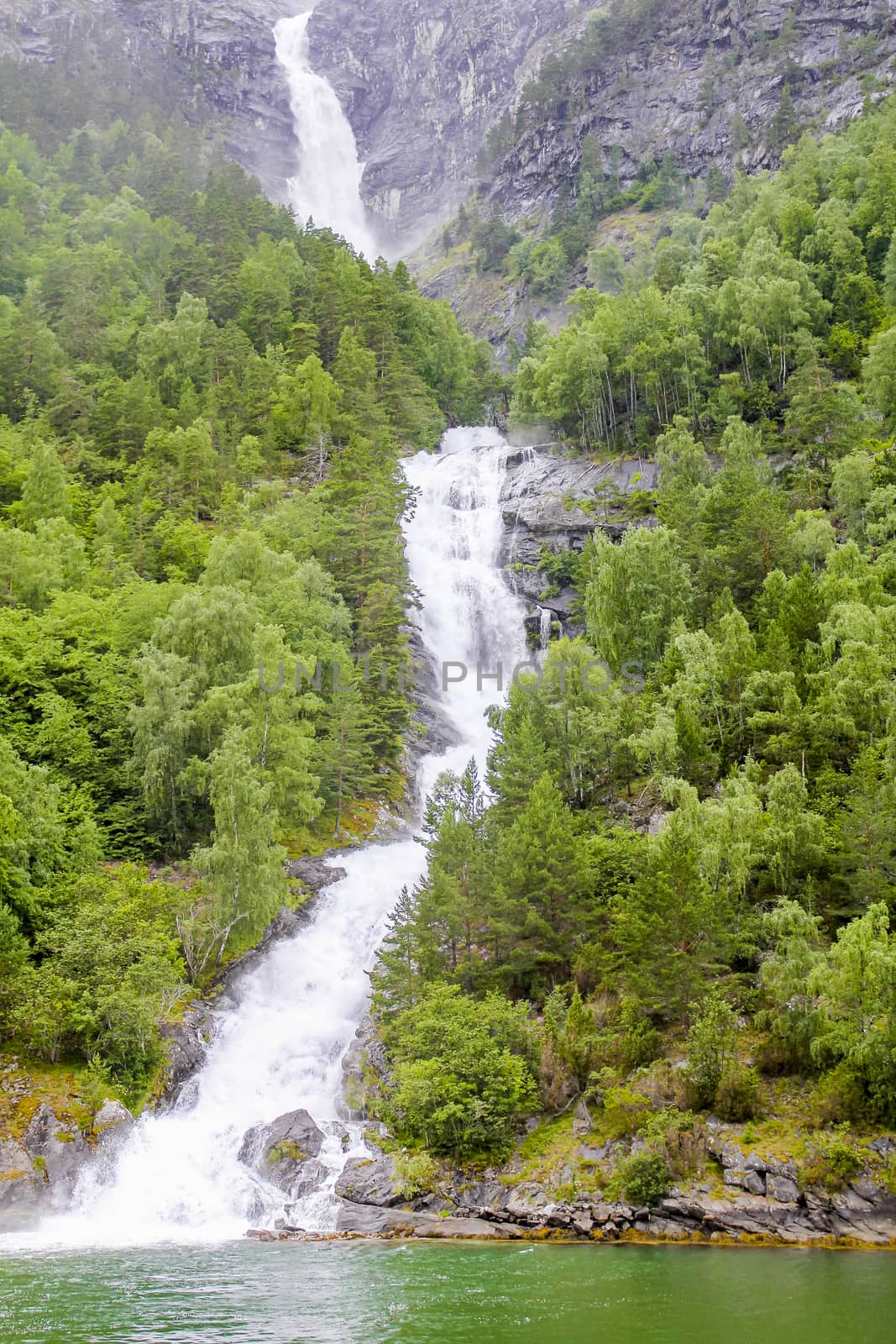 Waterfall in Aurlandsfjord Aurland Sognefjord in Norway. by Arkadij