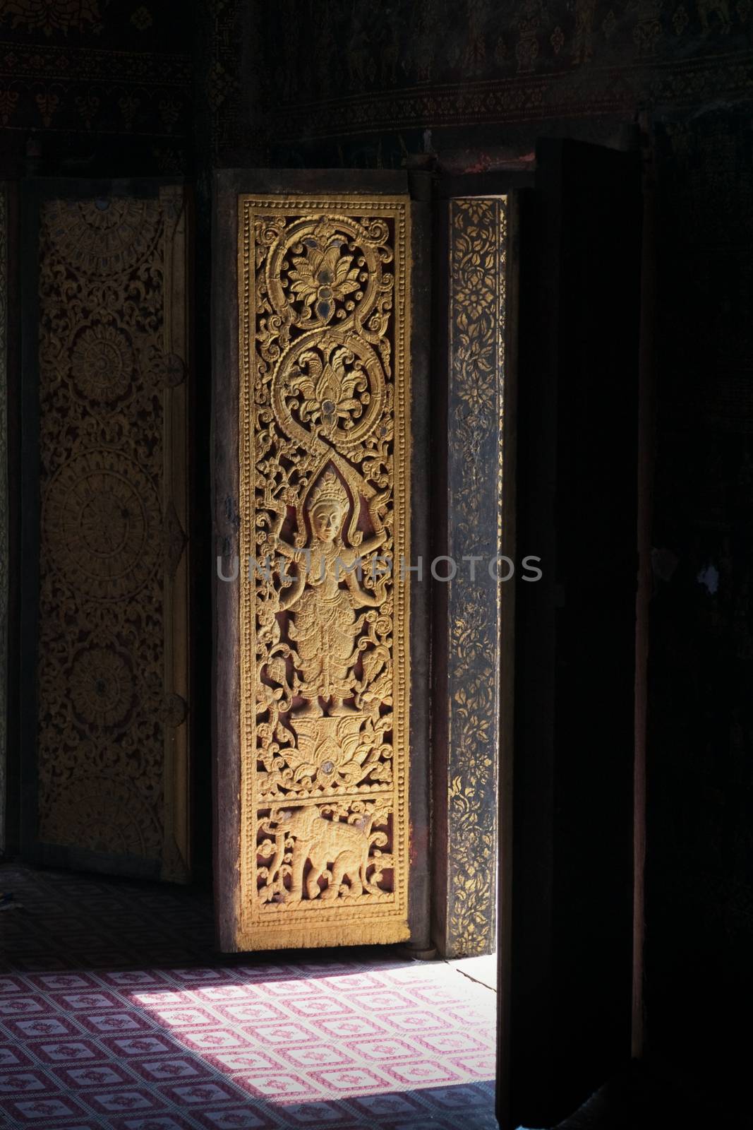 Temples at Luang Prabang Laos with Buddha statues and detailed golden shrines by kgboxford