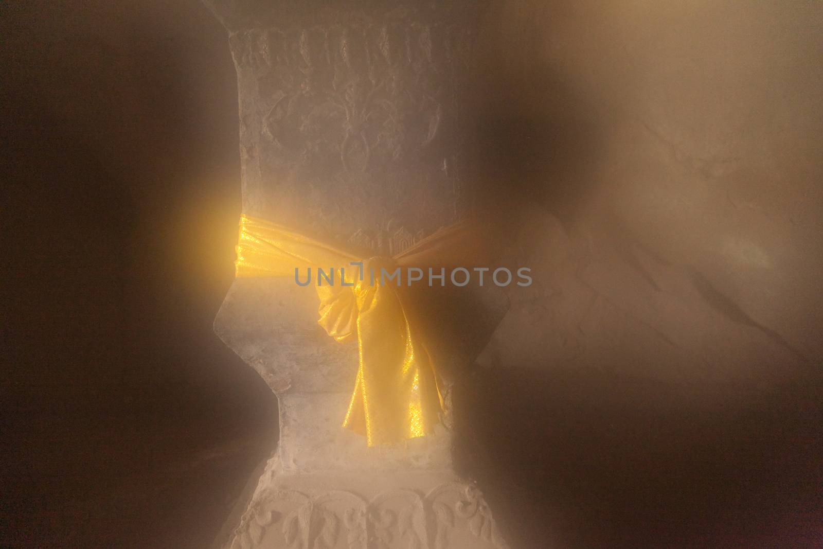 Ou Pak Caves Laos with yellow scarf tied to pillar in religious symbolism by kgboxford