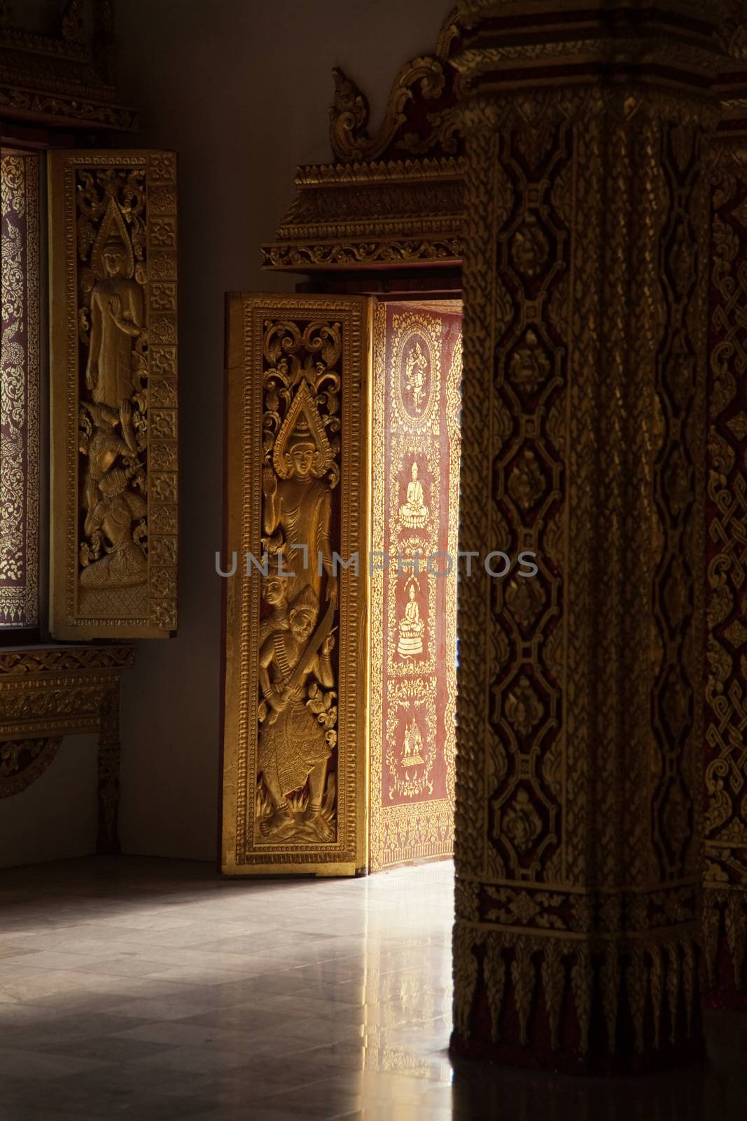 Temples at Luang Prabang Laos with Buddha statues and detailed golden shrines by kgboxford