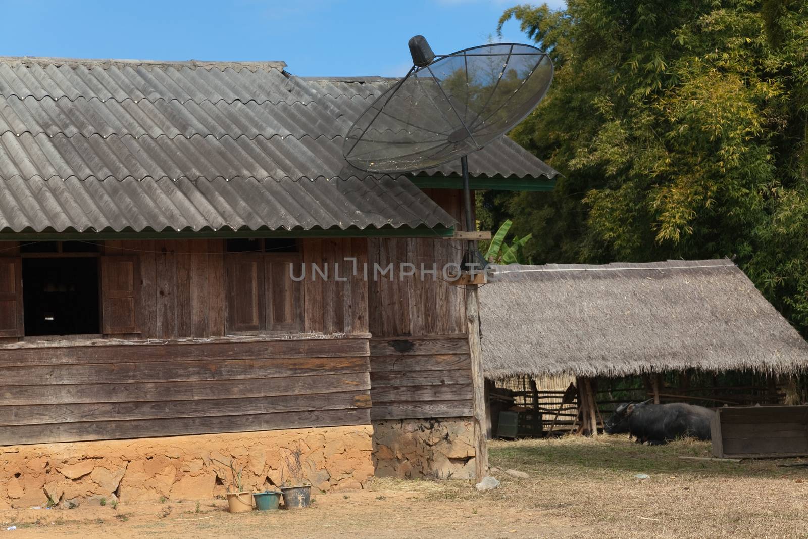 Ban Napia near Phonsavan Laos village houses where people make spoons from bombs leftover from Vietnam war and use empty bomb casings . High quality photo