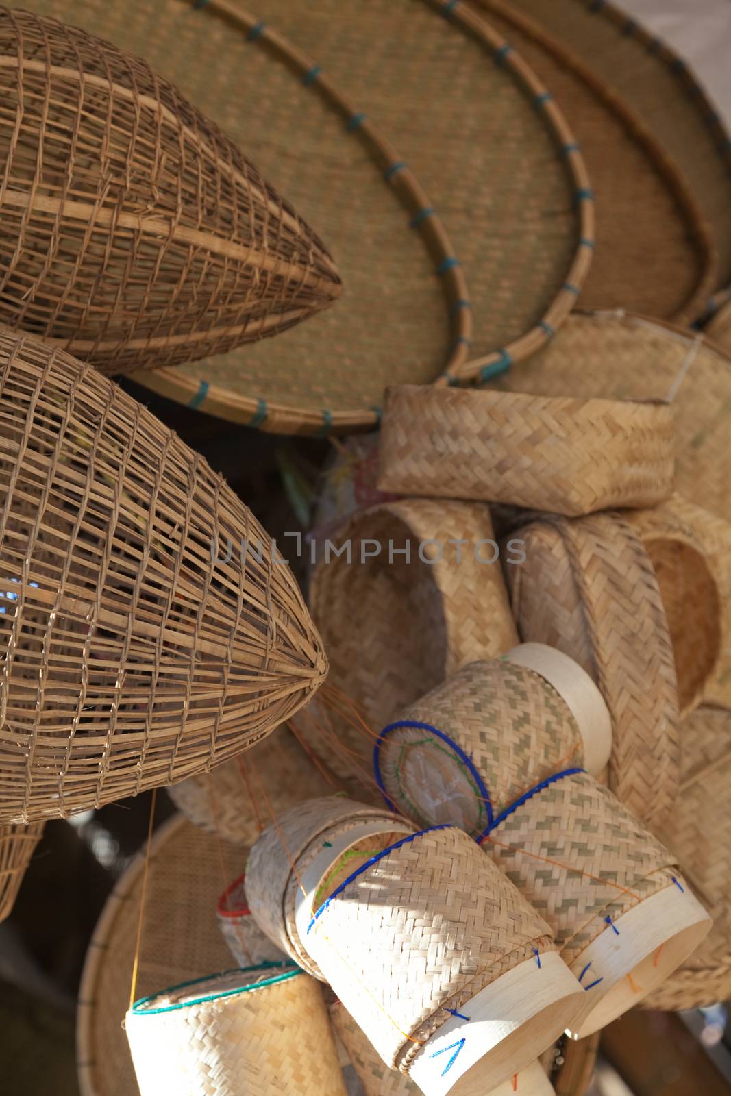 Laos, wicker woven reed baskets and containers in market, patterned weaving by kgboxford