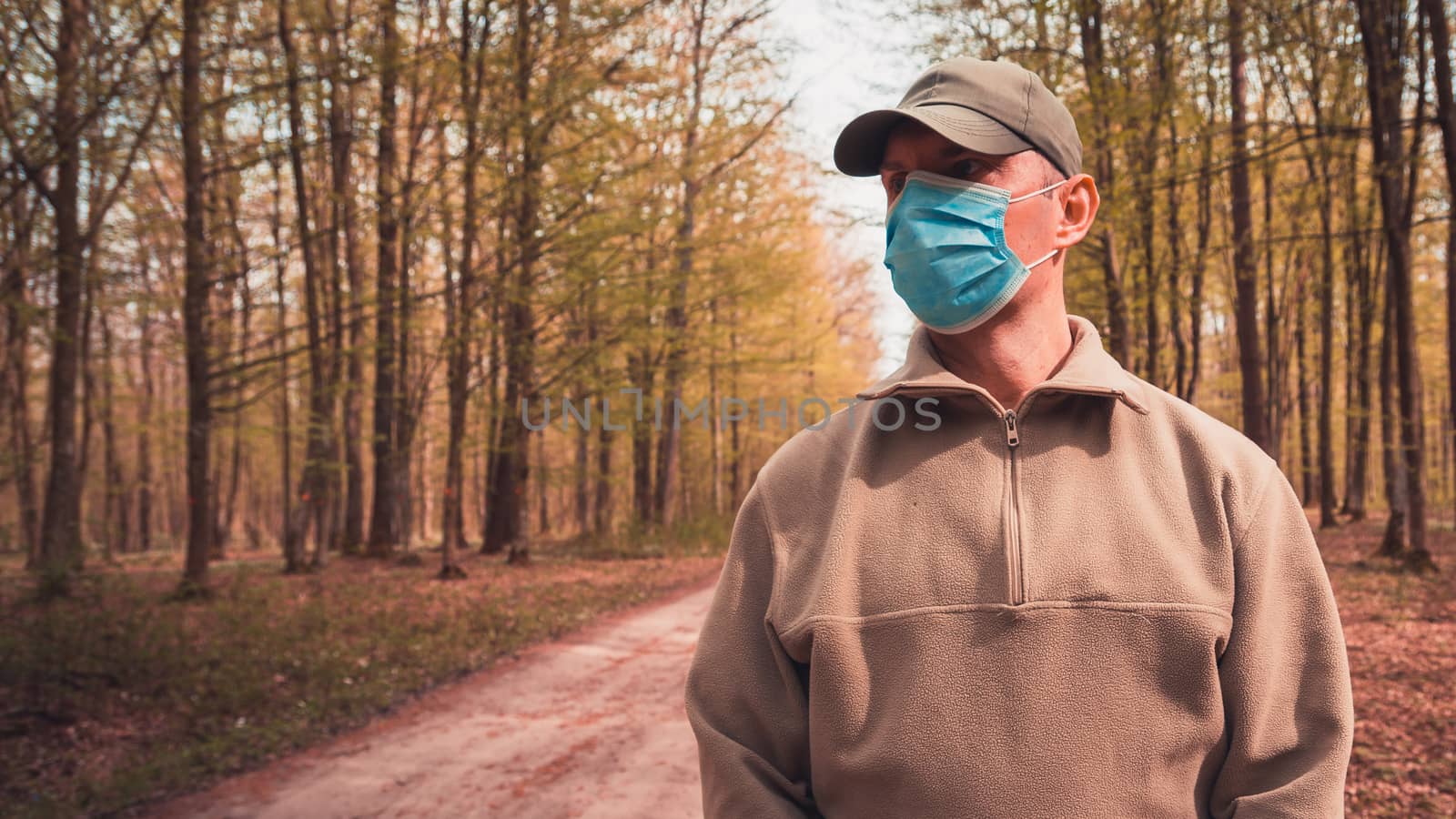 A man in a surgical mask in the woods by darekb22