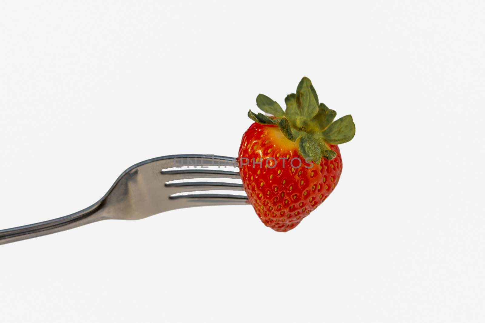 Strawberries on a fork cut out on a white background by ben44