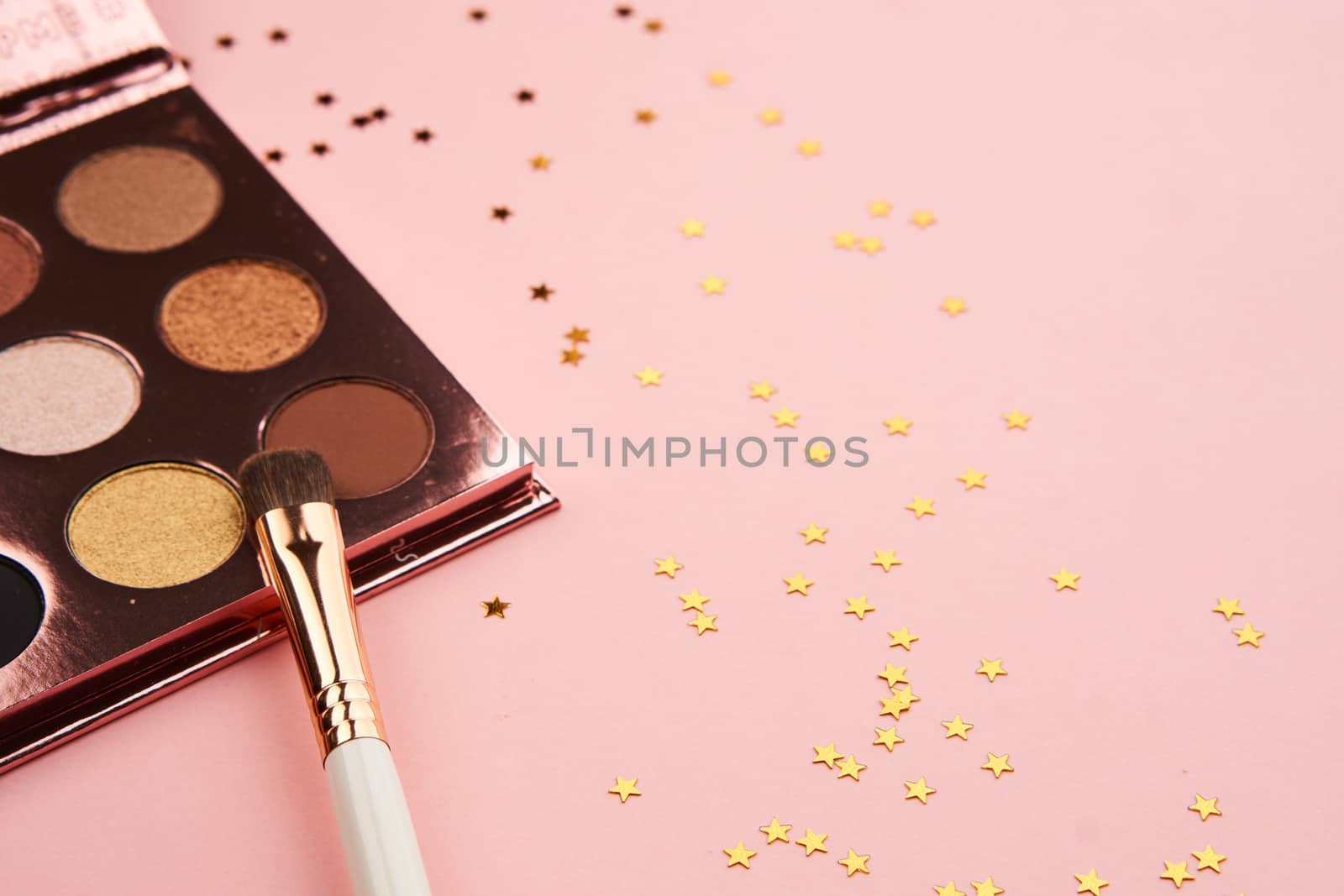 eyeshadow makeup brushes collection professional cosmetics accessories on pink background by SHOTPRIME