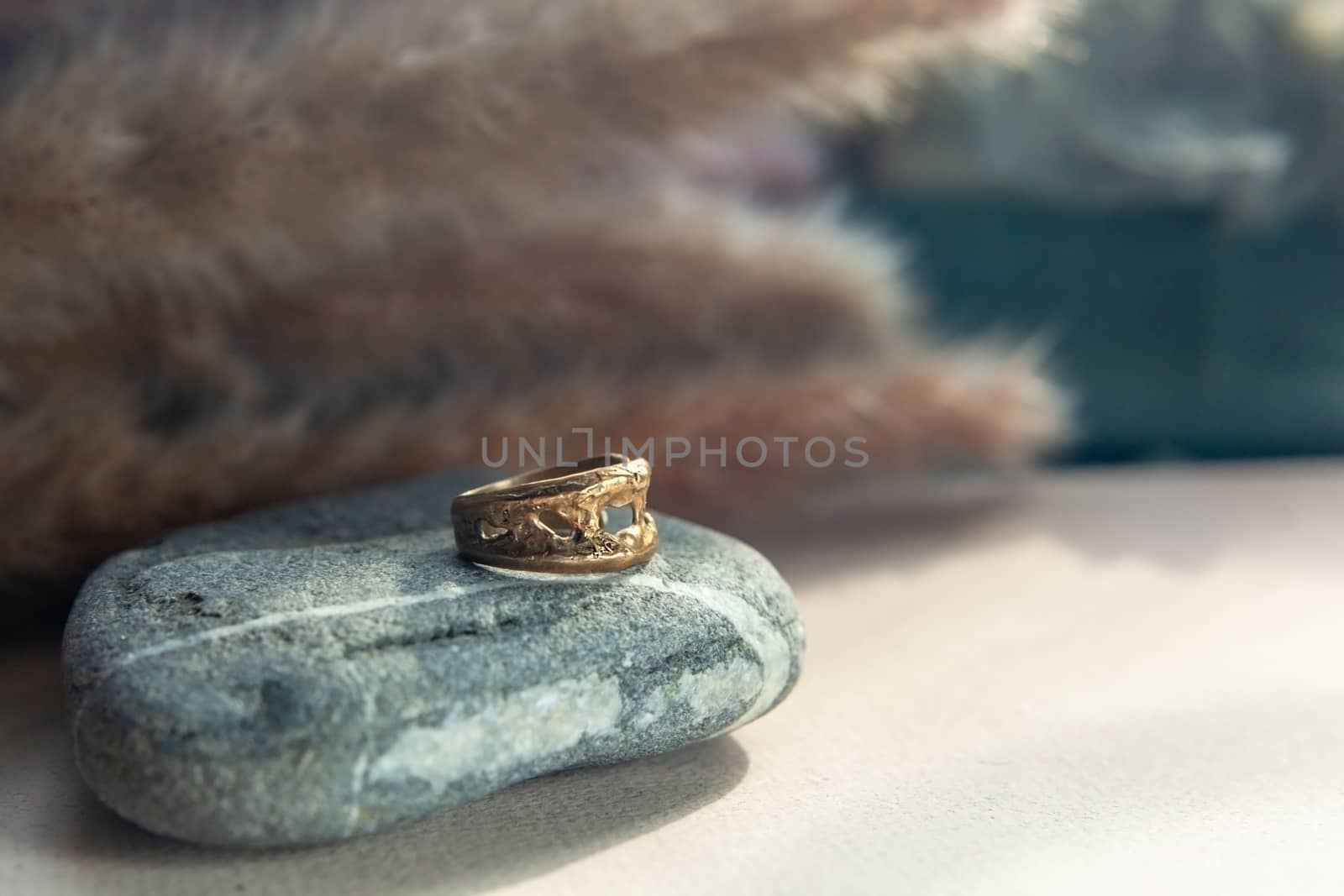 trendy vintage cast brass ring. jewelry womens ring abstract drawing closeup on a gray natural stone with shaddows
