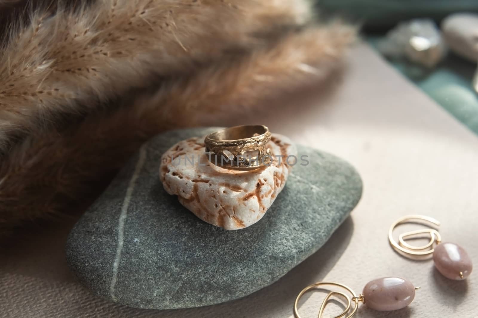 trendy vintage cast brass ring. jewelry womens ring abstract drawing closeup on a gray natural stone with shaddows