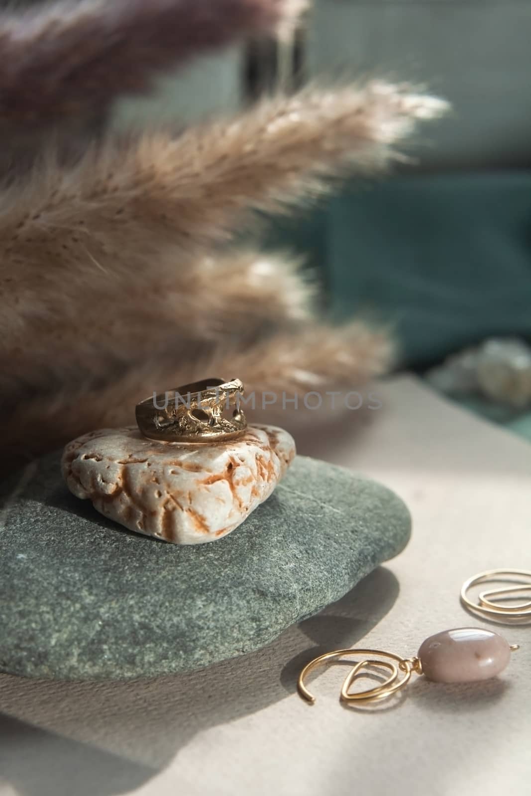 trendy vintage cast brass ring. jewelry womens ring abstract drawing closeup on a gray natural stone with shaddows