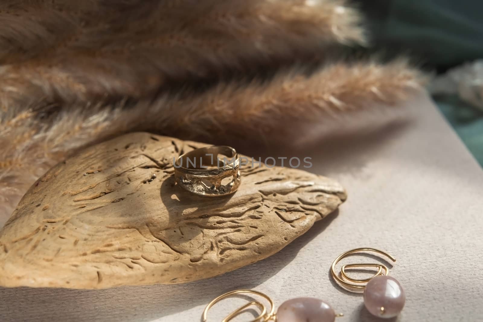 trendy vintage cast brass ring. jewelry womens ring abstract drawing closeup on a gray natural stone with shaddows