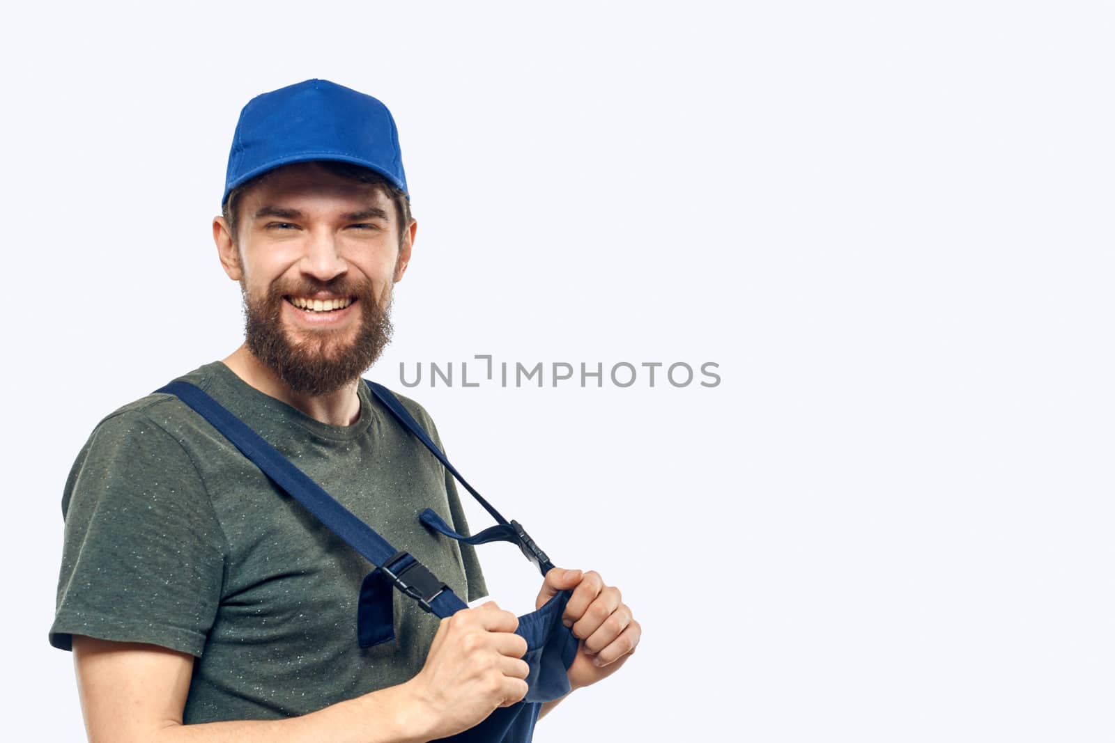 Worker man uniform delivery service emotions studio light background. High quality photo