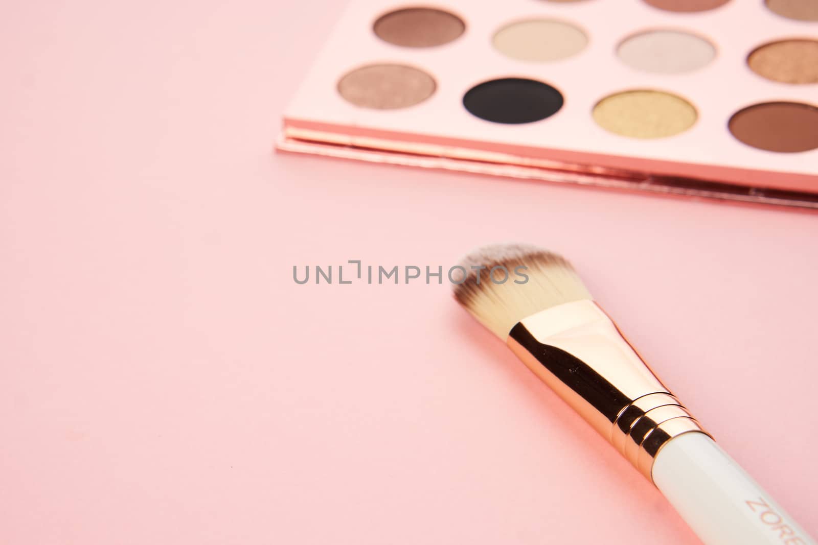 makeup brushes and eyeshadow professional cosmetics on pink background. High quality photo