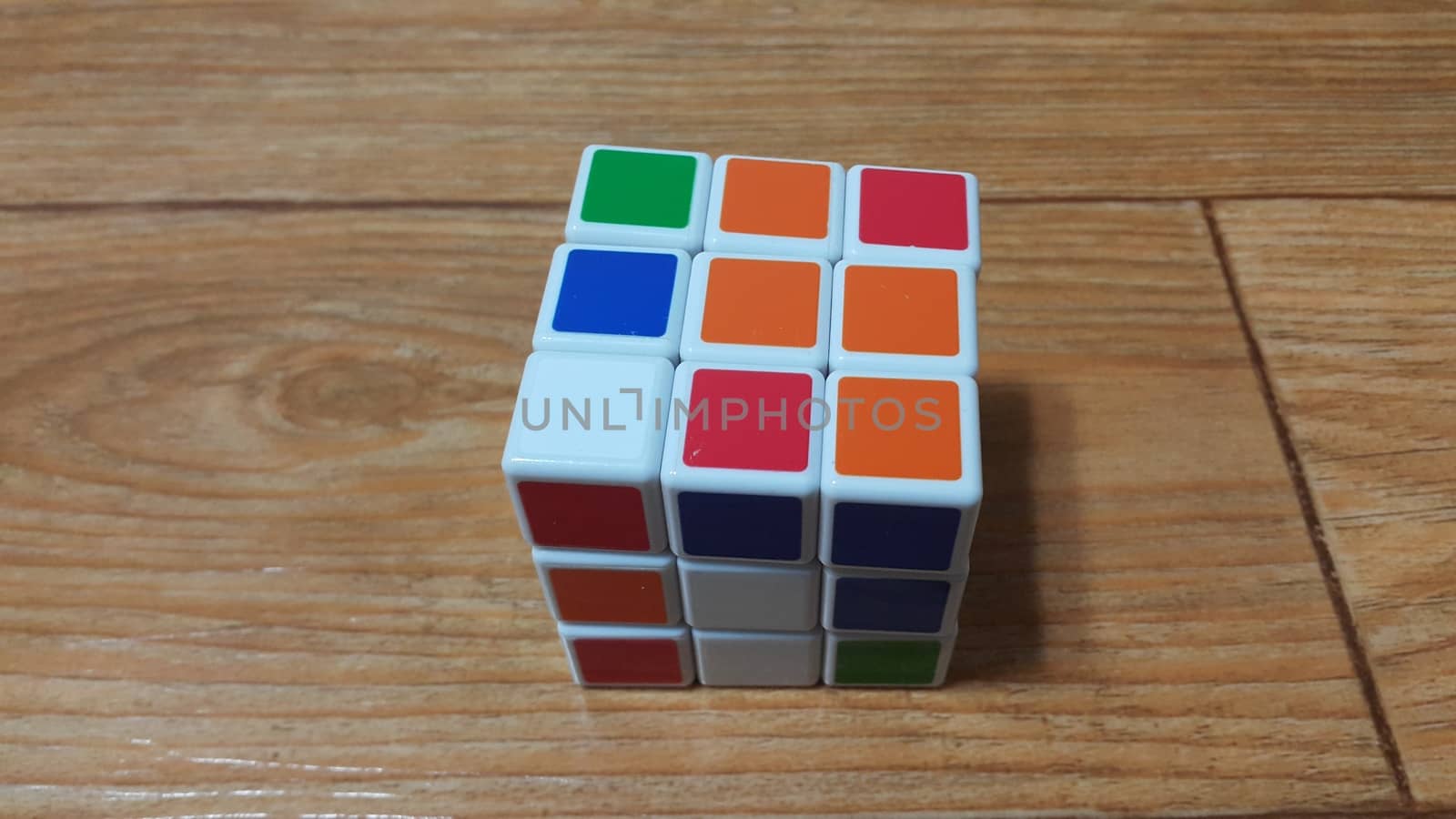 SOUTH KOREA, 08 OCTOBER-2018: Close up view of Rubik cube on wooden floor. A modern toy for mind and logical games.