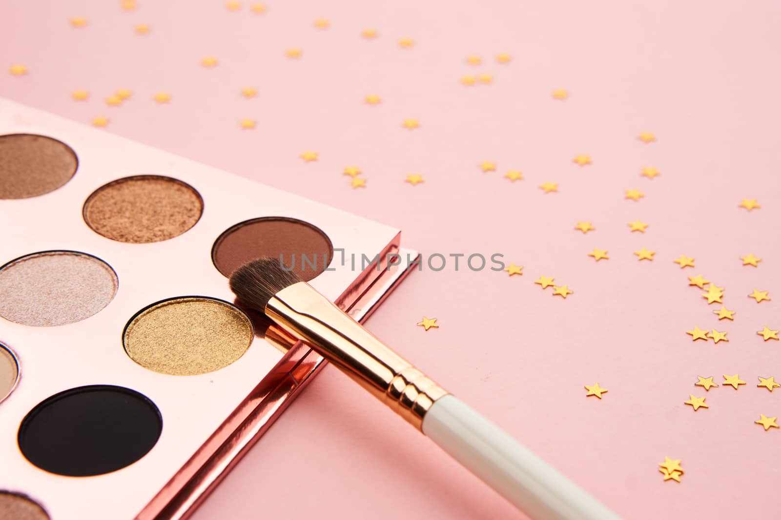 eyeshadow makeup brushes collection professional cosmetics accessories on pink background by SHOTPRIME