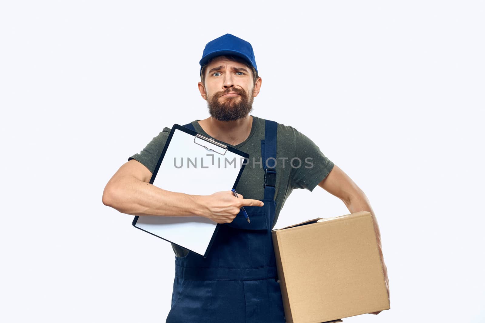 Man in working uniform box delivery loader courier light background. High quality photo