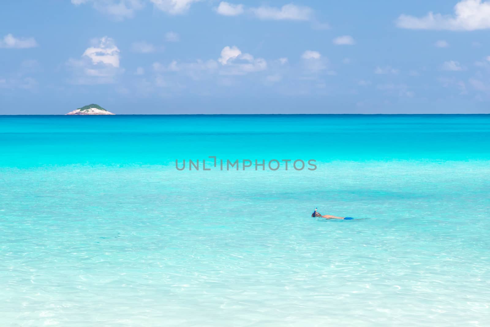 The beach of the Seychelles with blue water and stones by 25ehaag6