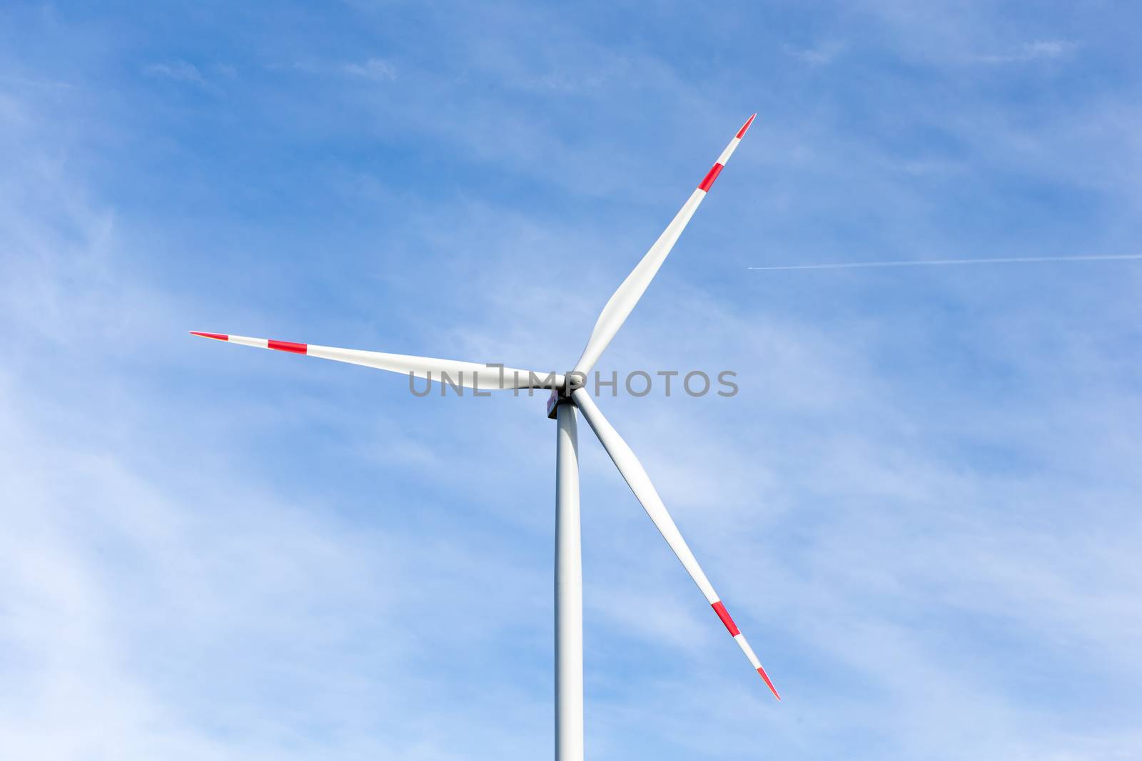 The windmill with a blue sky in the background