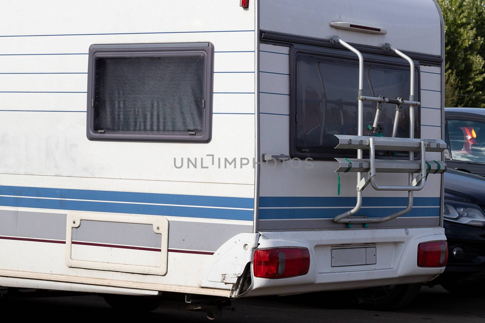 Caravan trailer, mobile home for family travel, close-up. Camping concept, hyper-local travel, family outings.