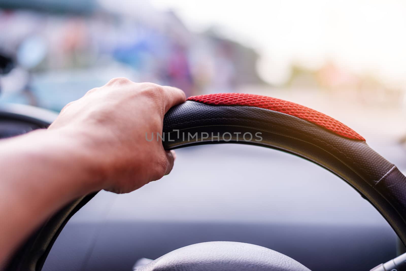Driving concept, Hand driving a car on the road blurred background
