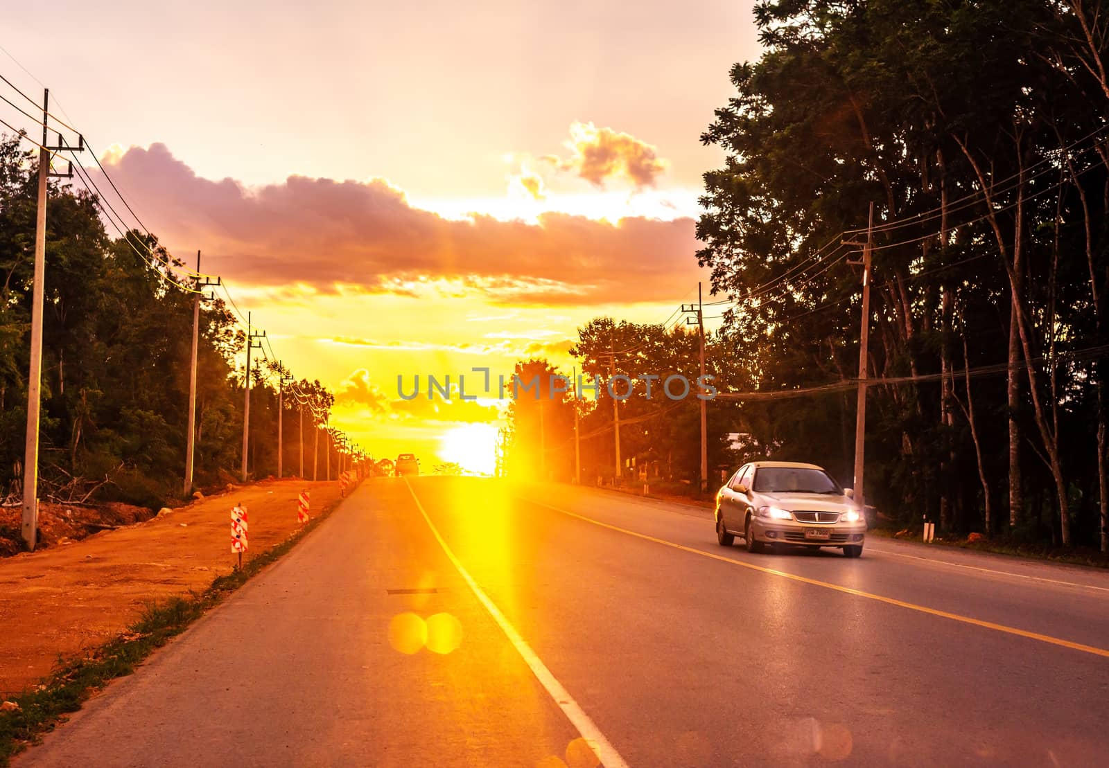 Pattalung, Thailand - August 29, 2020 : Road with car and colorful of sunset or sunrise in twilight