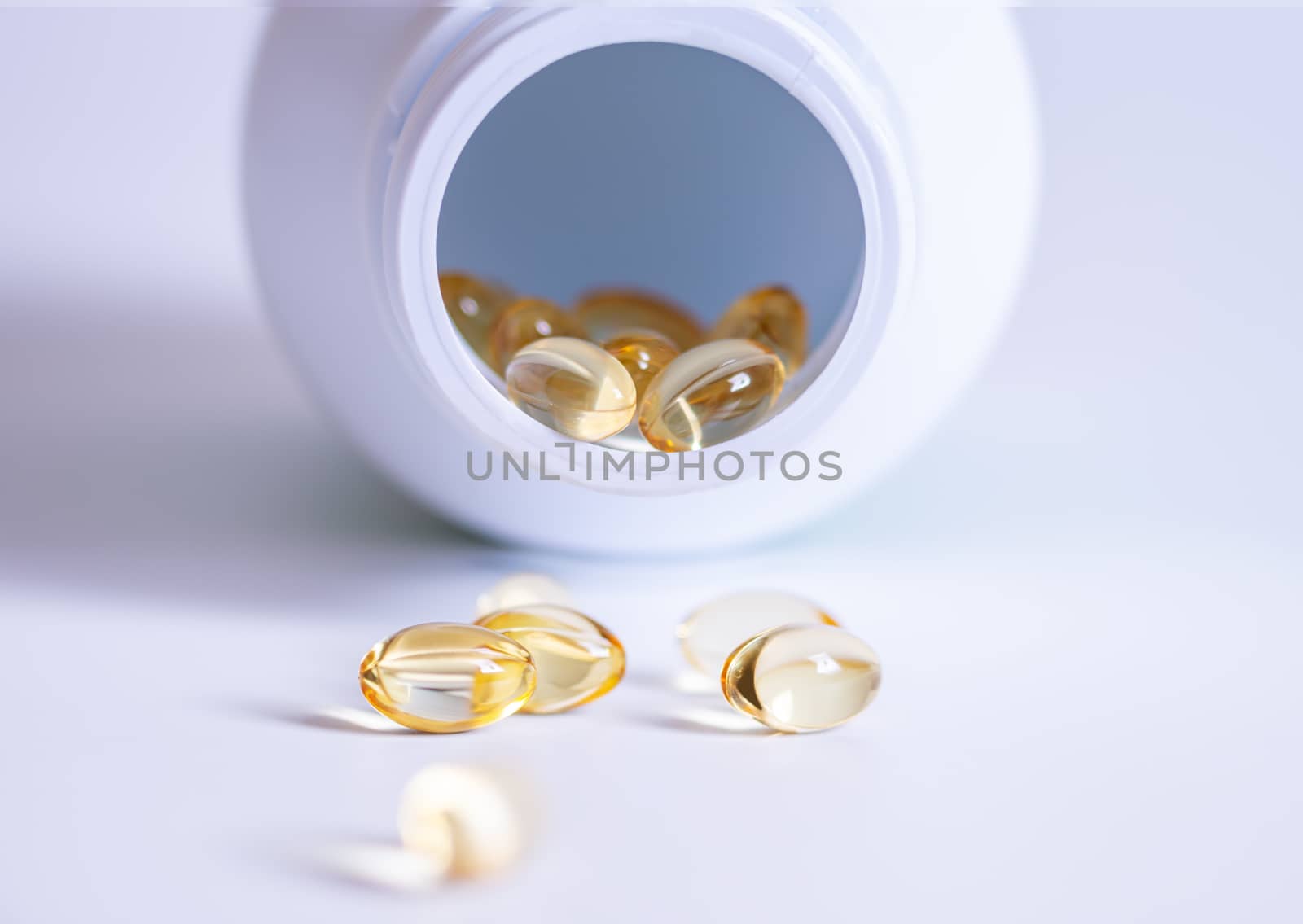 Pill spilling out of a bottle blurred background, Medicine capsule for health, Vitamin spilling out from bottle, Macro