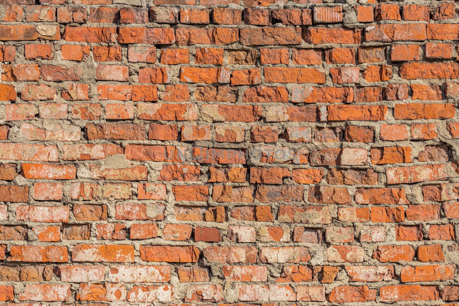 heavily weathered brick wall texture and background with deep water erosion.