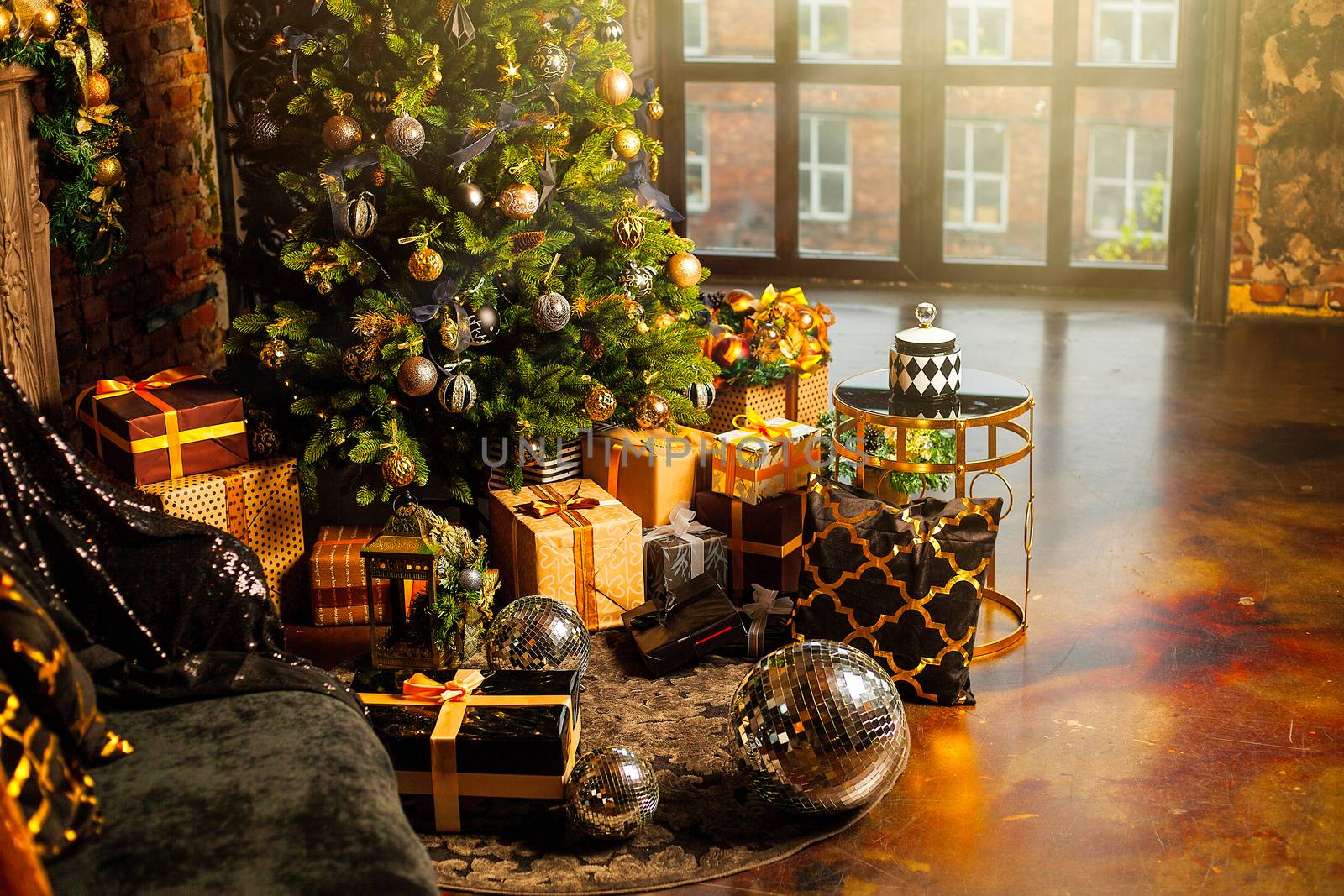 Christmas tree decorated with gold balls. Under the Christmas tree a large number of Christmas gifts. Christmas holiday concept. A huge number of gift boxes under Holiday background