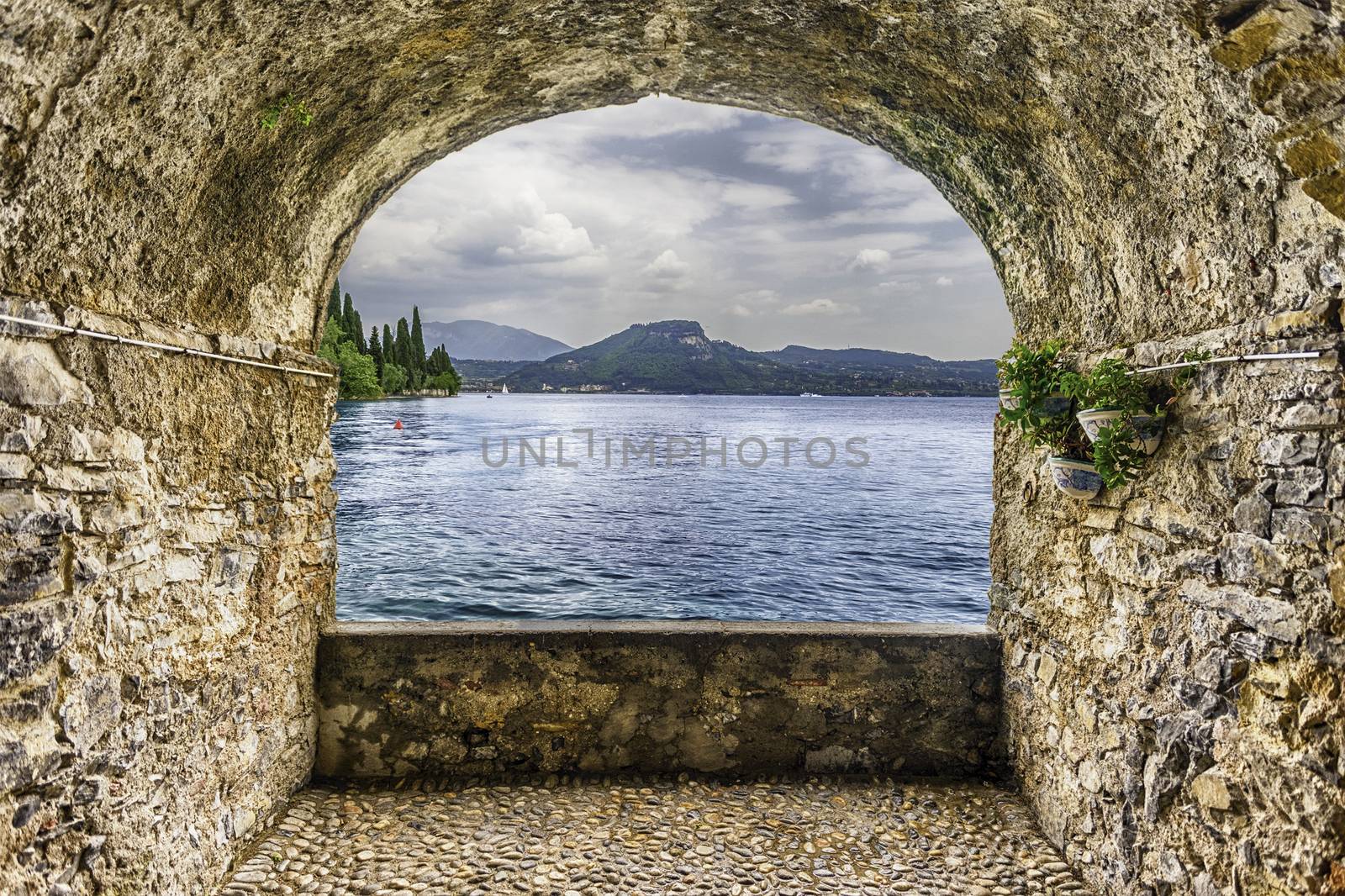 Scenic rock arch balcony overlooking Lake Garda from the town of Torbole, Italy
