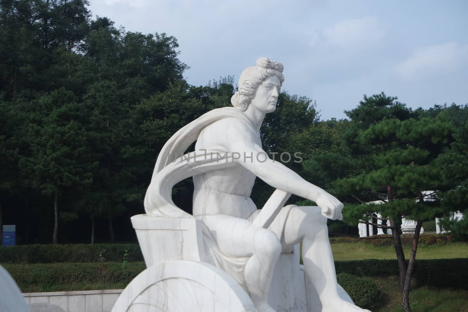 White marble stone statue of sitting Poseidon or Neptune