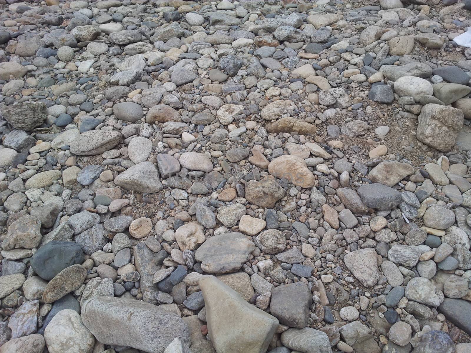 Transparent water surface with copy space for background and texture. Transparent water texture with view of stones under water.