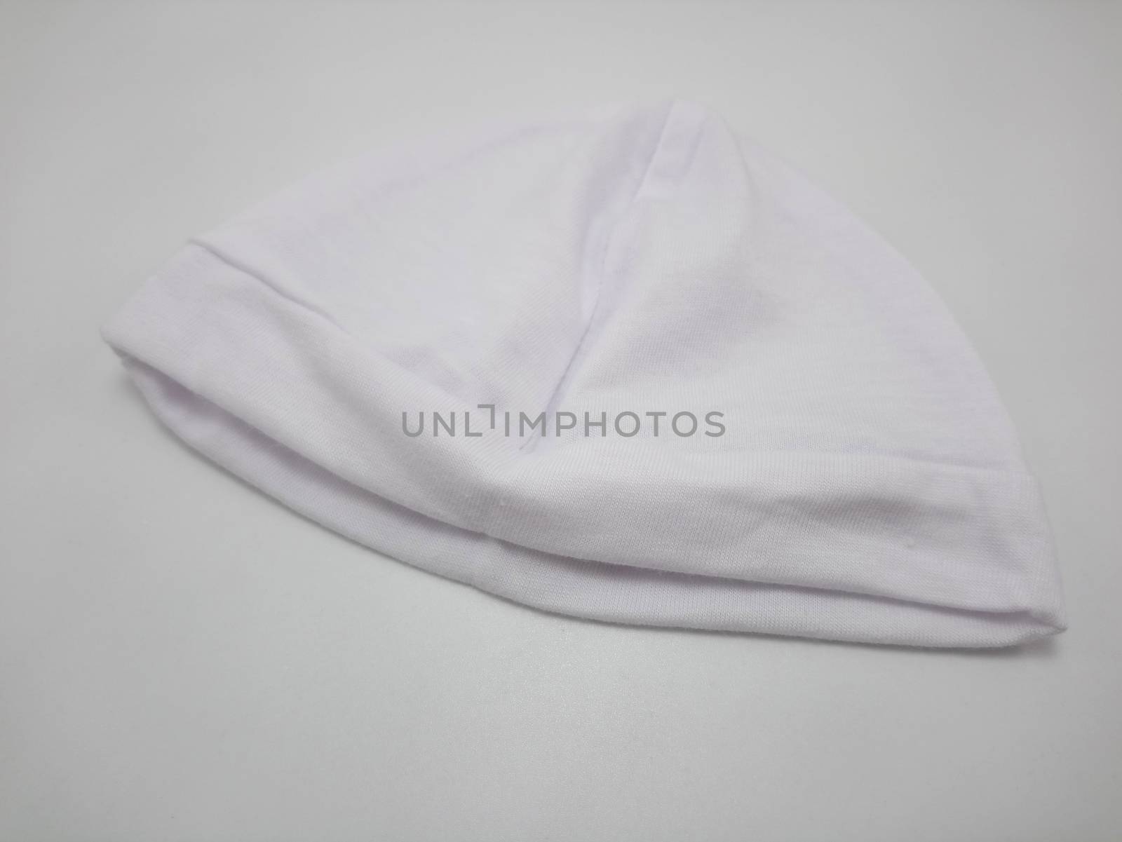 White plain baby head bonnet use to cover the head of person during cold condition